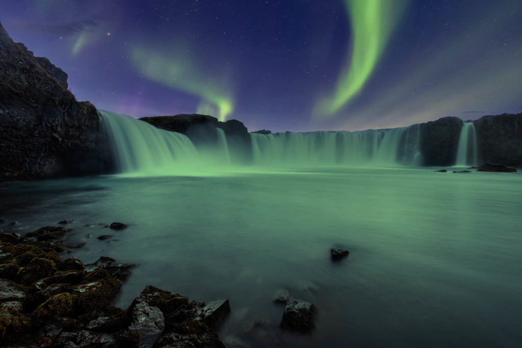 Aurora Borealis over Godafoss waterfall in Iceland