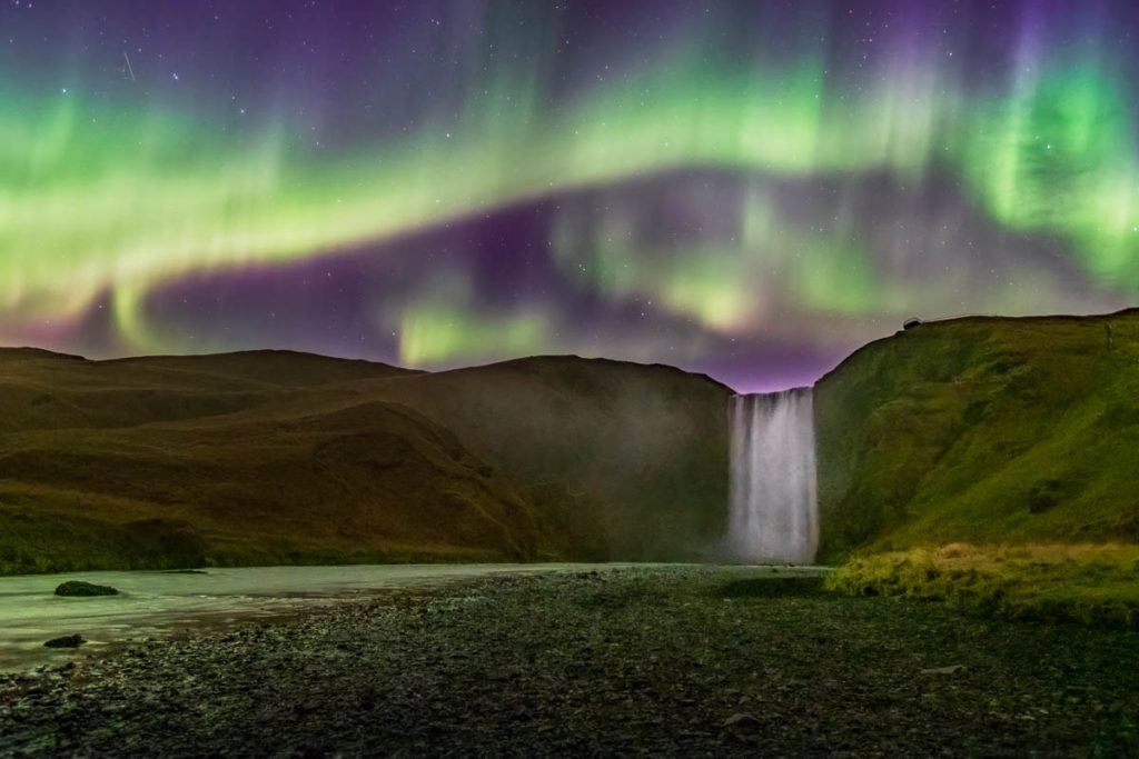 Aurora Borealis over Skogafoss Waterfall in Iceland