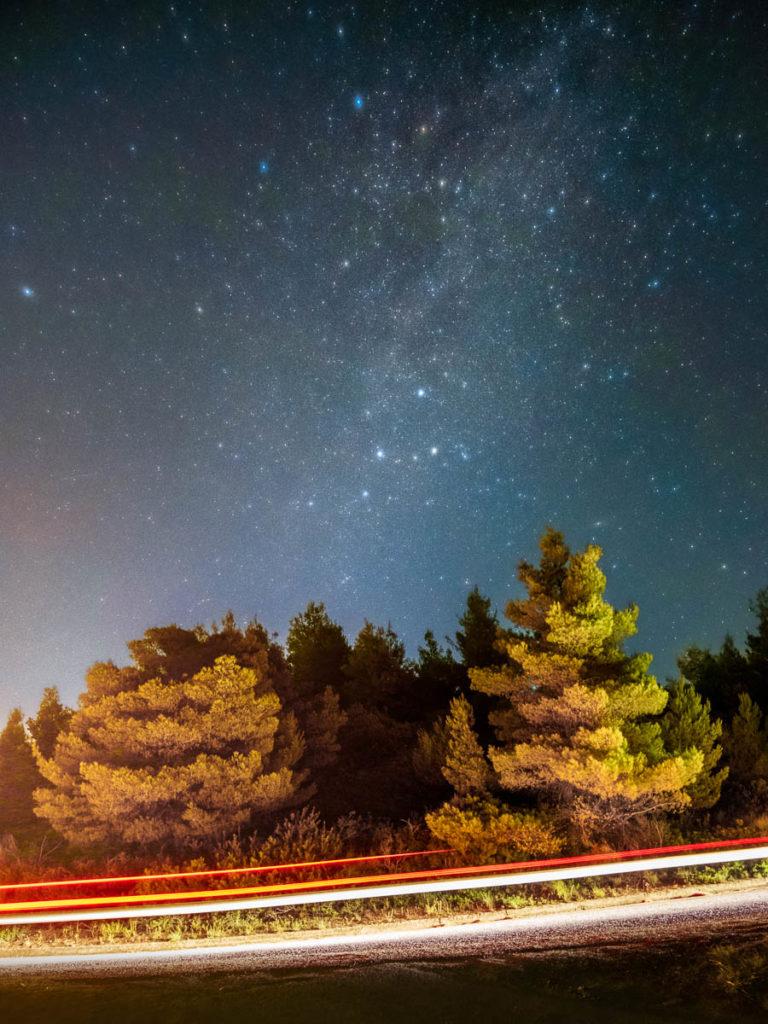 Car Light Trails under the Starry Night Sky